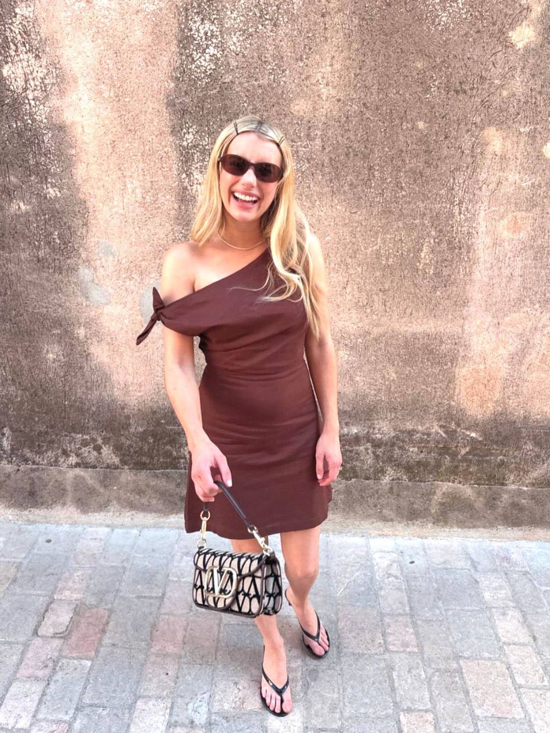 Emma paired the luxury piece with a draped chocolate dress by Showpo