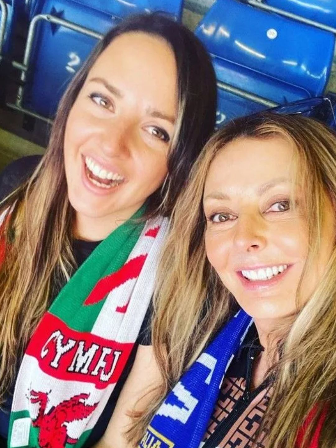 Carol Vorderman and daughter Katie in a sports stadium - Katie has a Welsh flag scarf