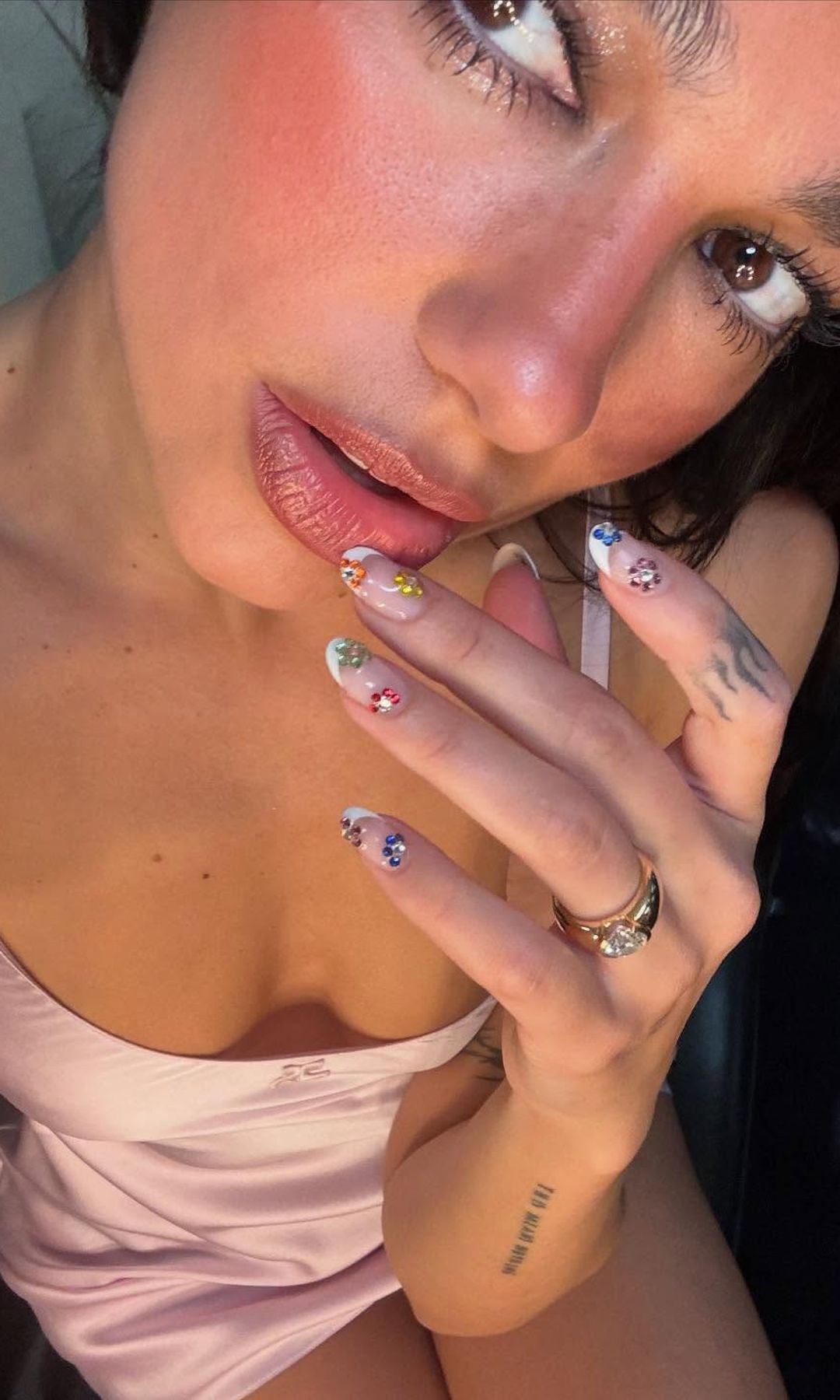 Dua Lipa poses in a pink mini dress