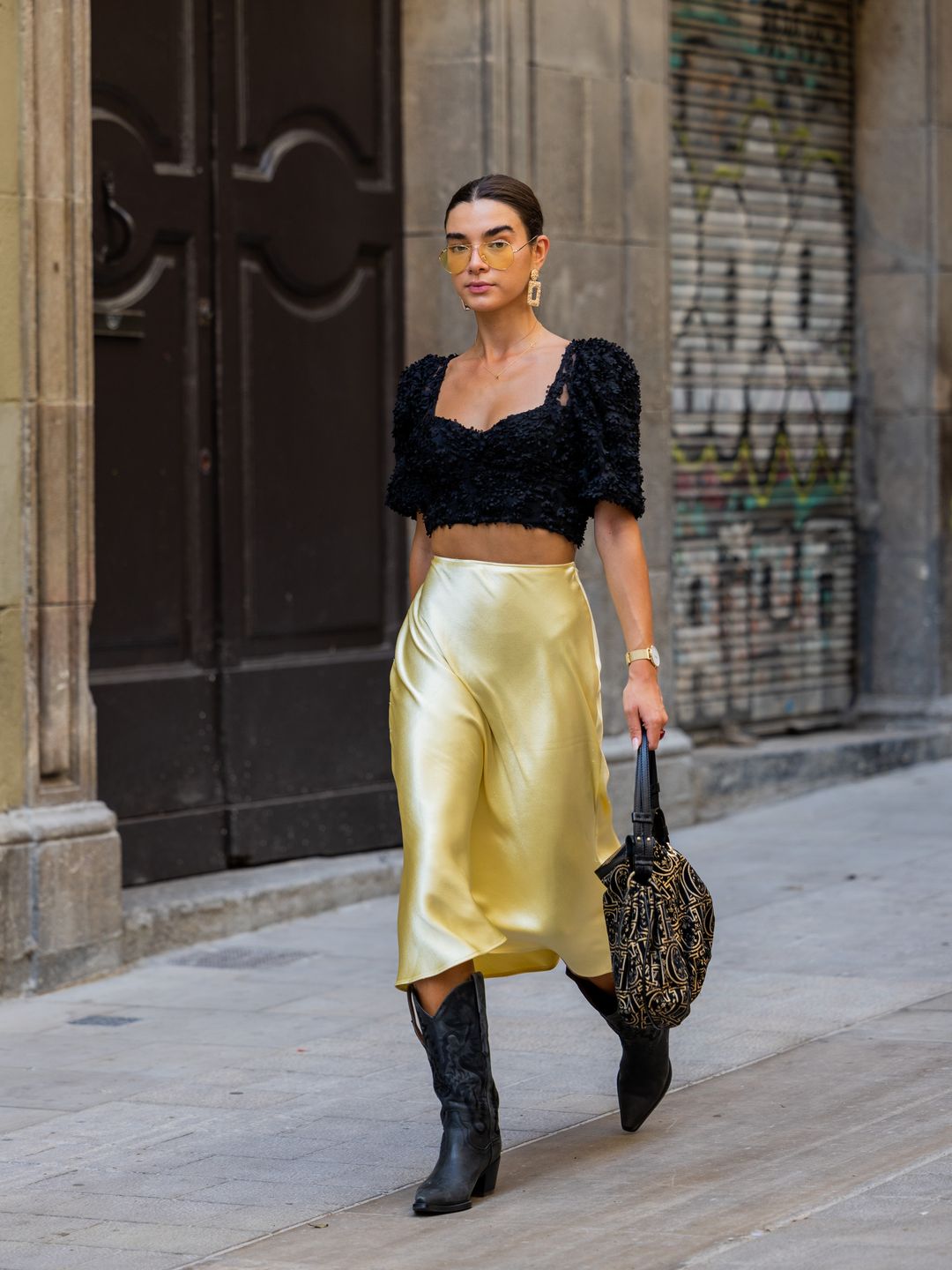 Martina Canales wears cowboy boots with a molten gold skirt 