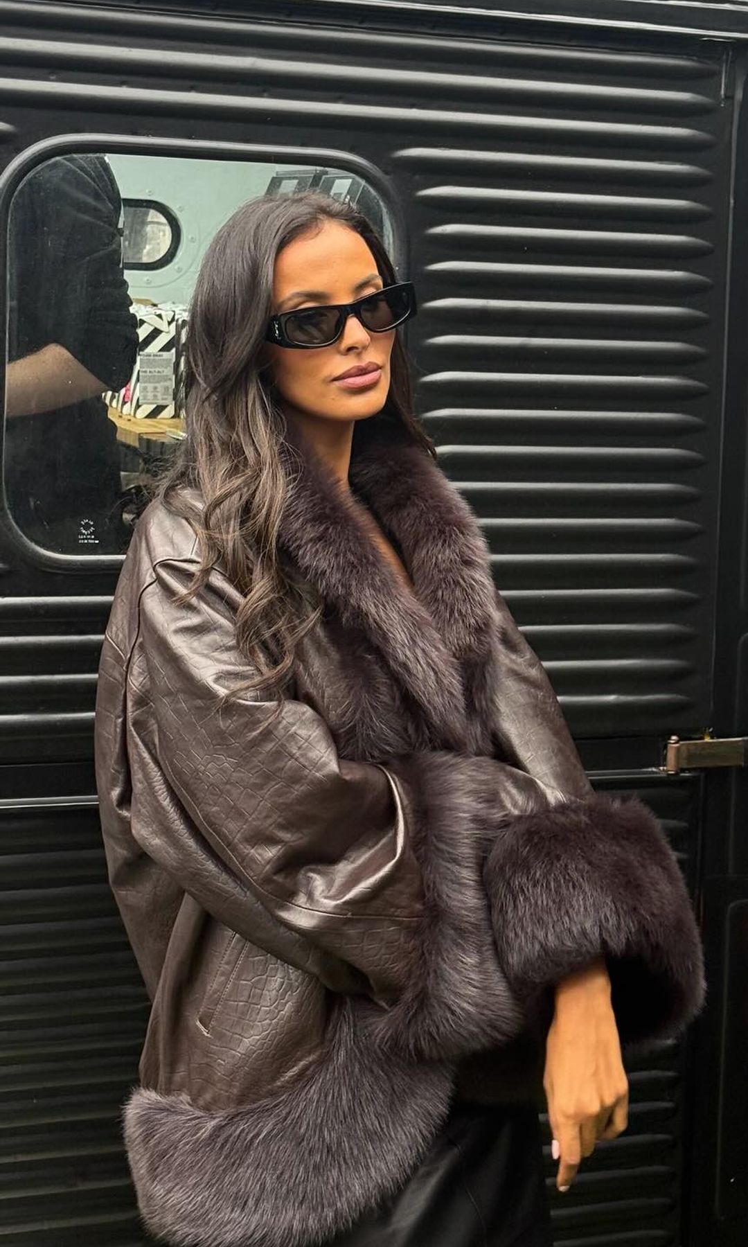 Maya Jama poses in a brown leather coat