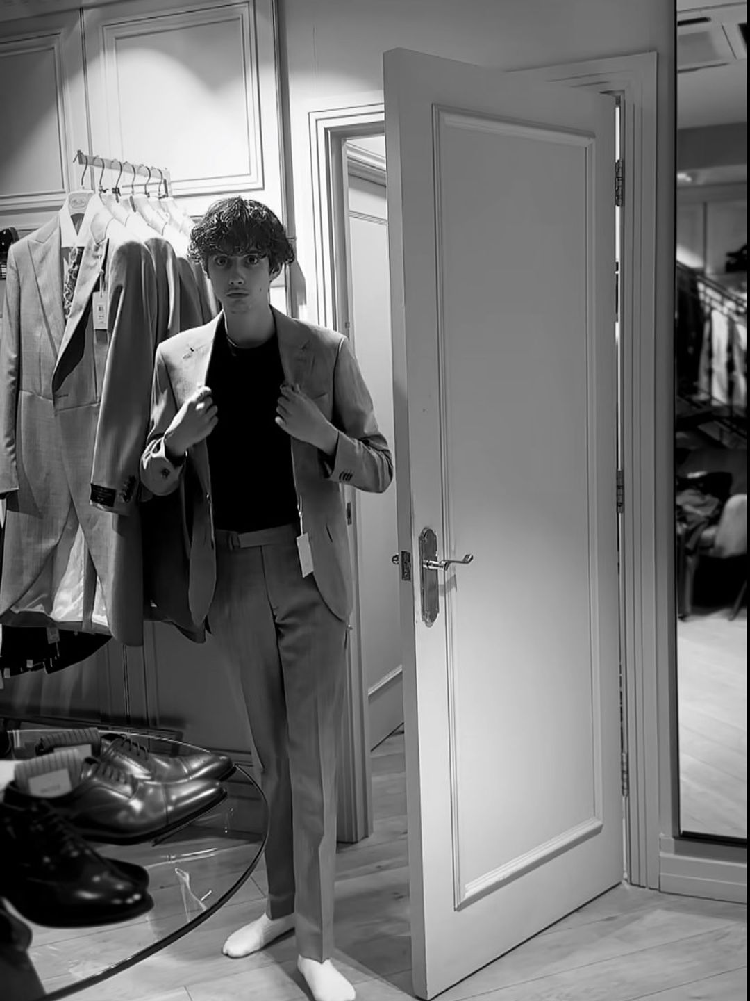 Zachary looking smart trying on suits