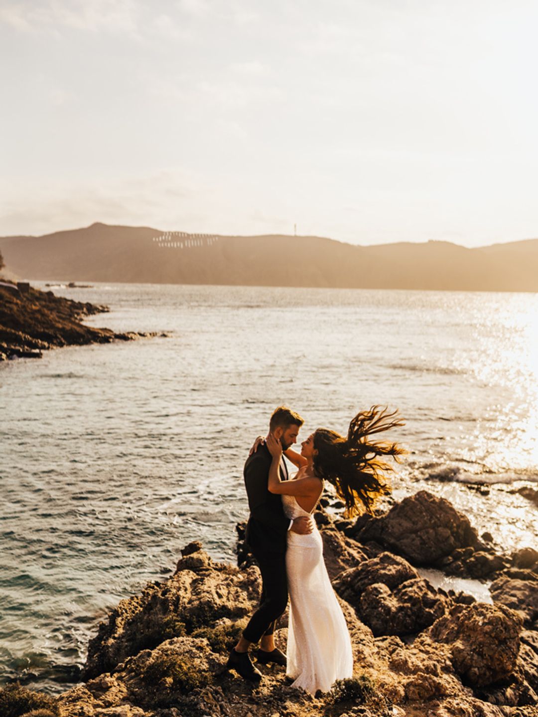 Bride and groom on the oceans edge