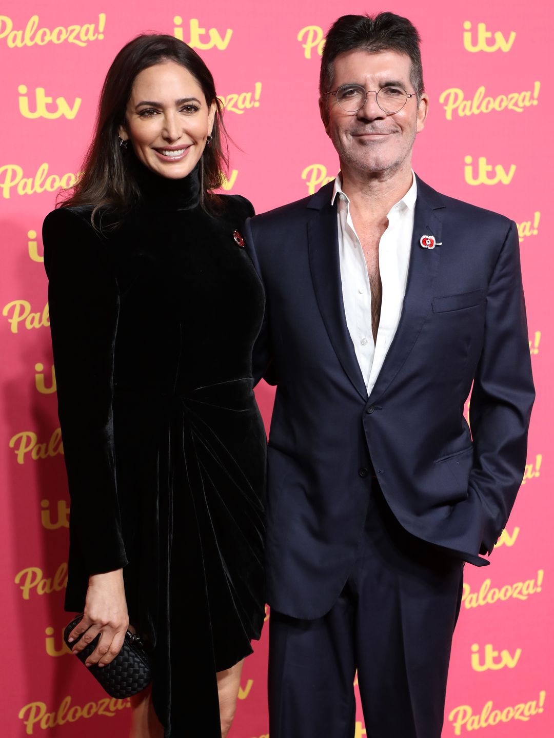 Simon and Lauren smiling on a red carpet
