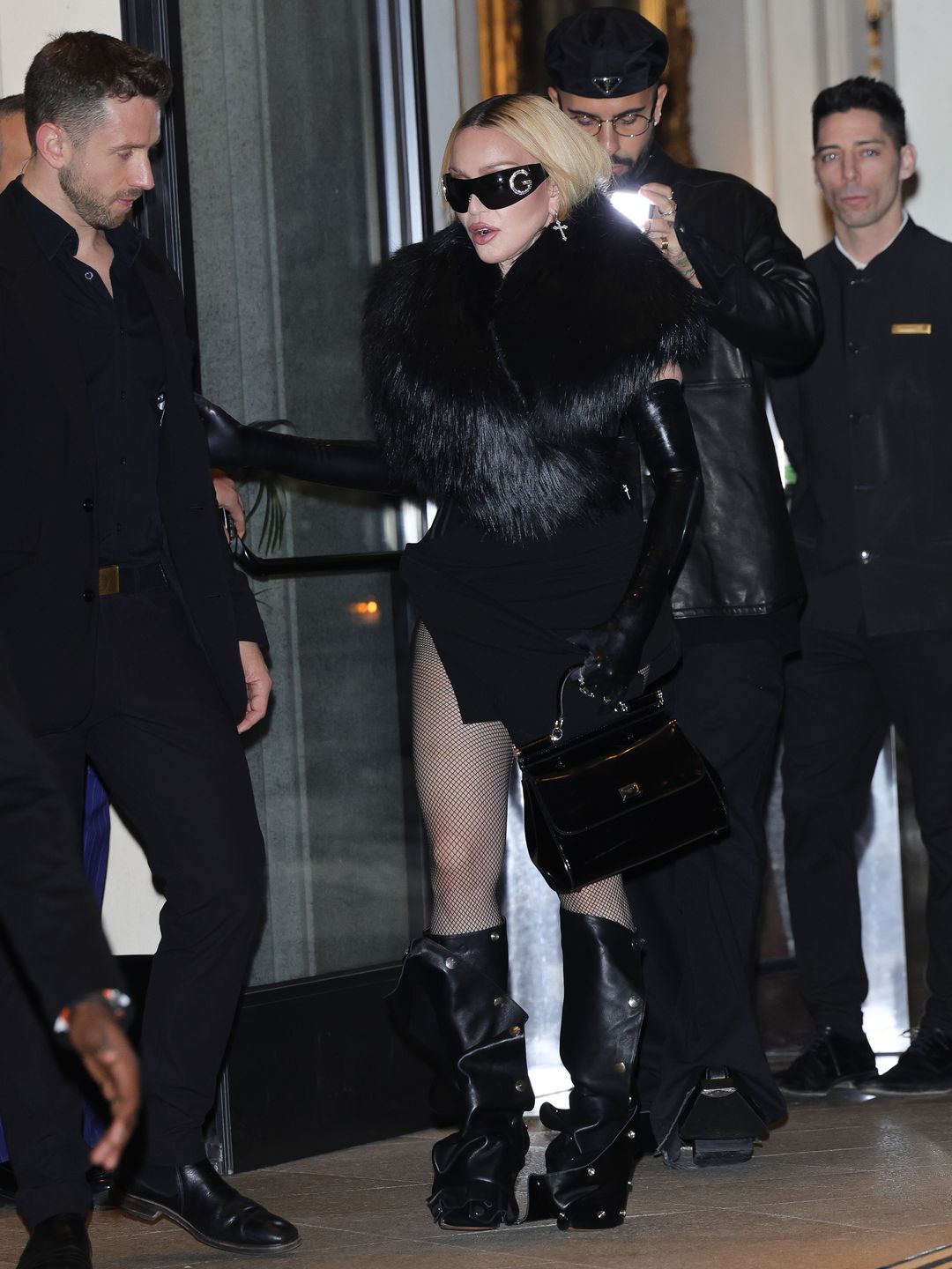 Madonna wearing black mini dress and fishnet tights