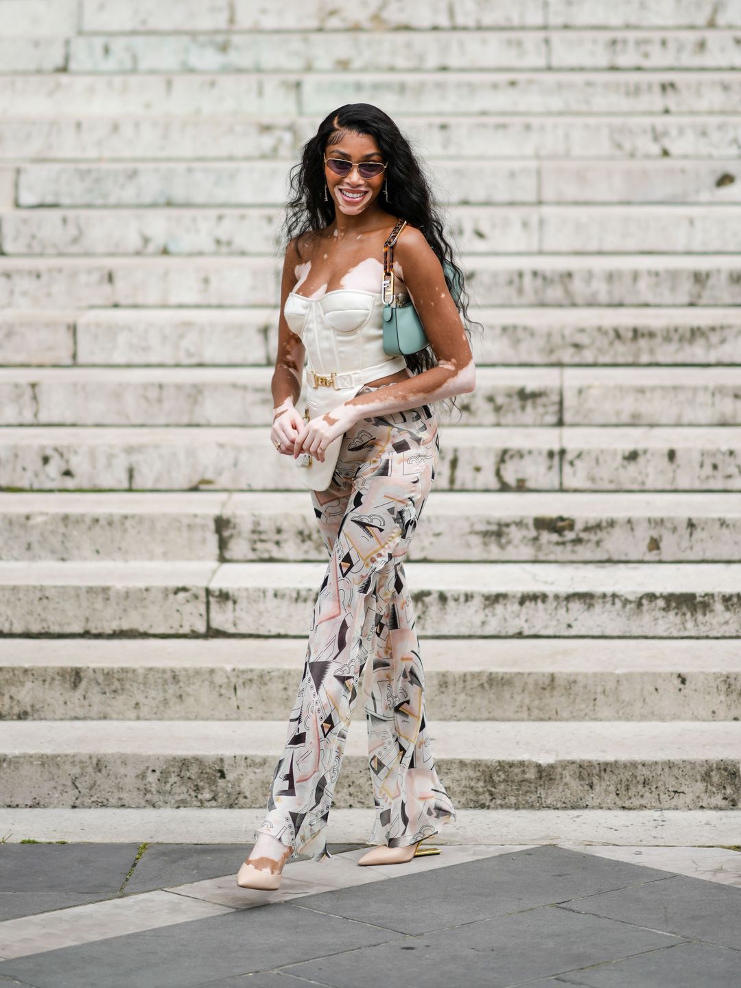 Winne Harlow wearing a corset and printed trousers