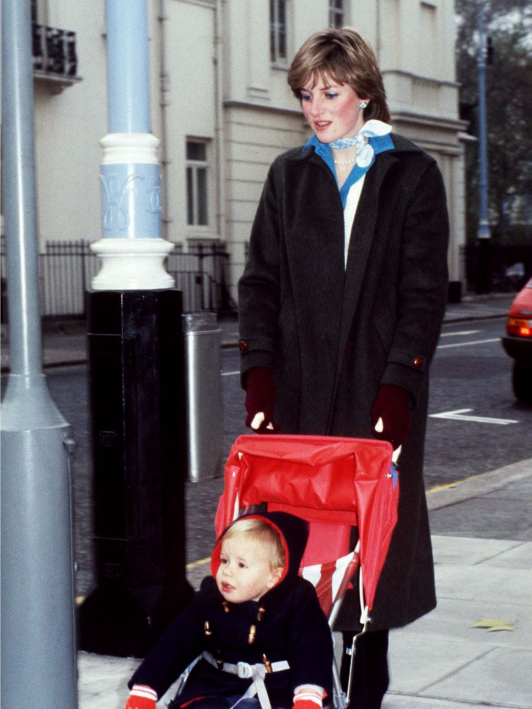 Princess Diana pushing a baby boy in a buggy