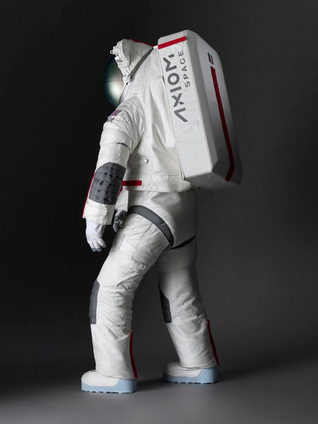 The spacesuit seen from behind, featuring red stripe and grey block designs