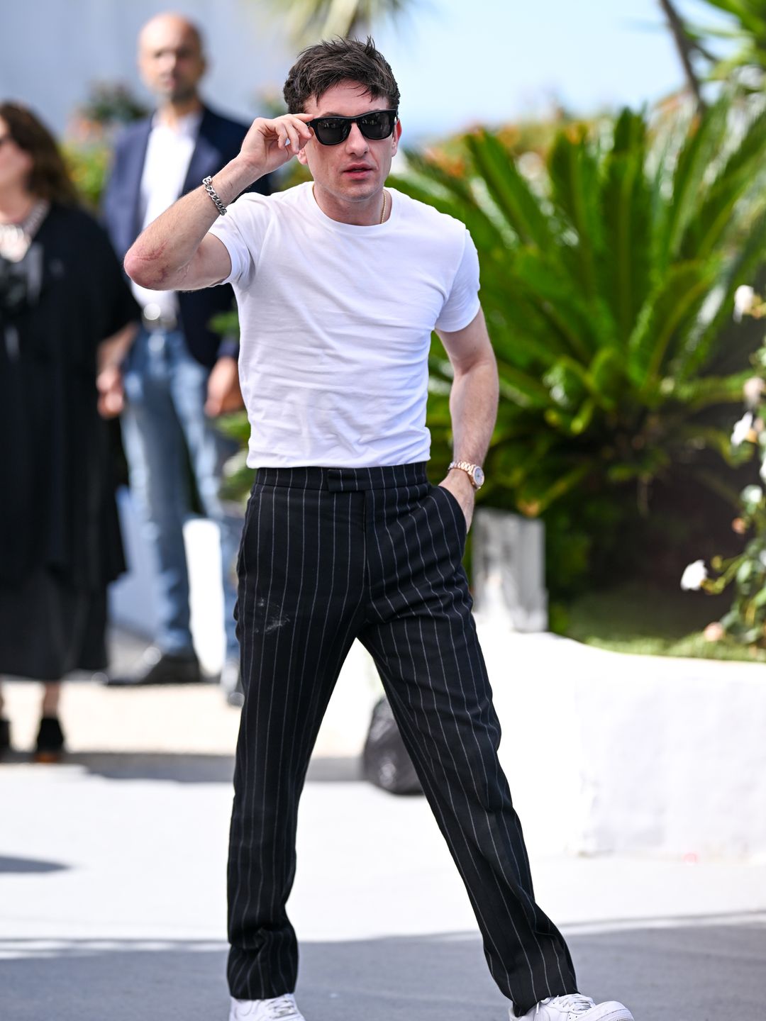 Barry Keoghan in a white shirt, pinstripe trousers and sunglasses