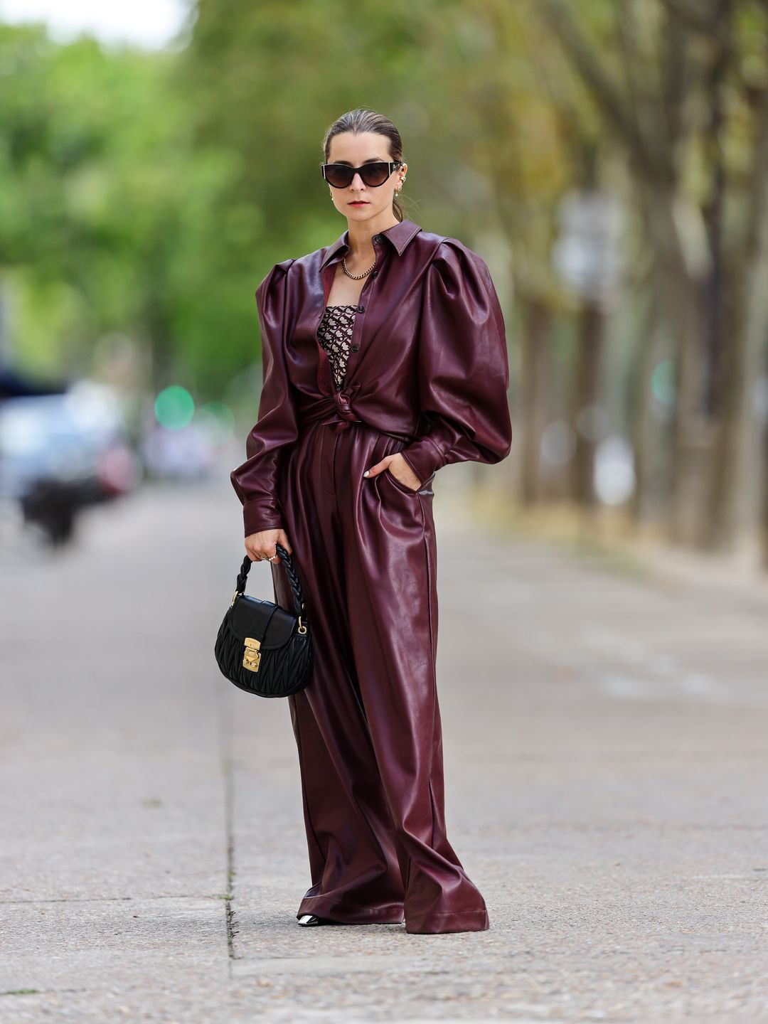 Julia Comil wears a burgundy puff-sleeve shirt and matching trousers 