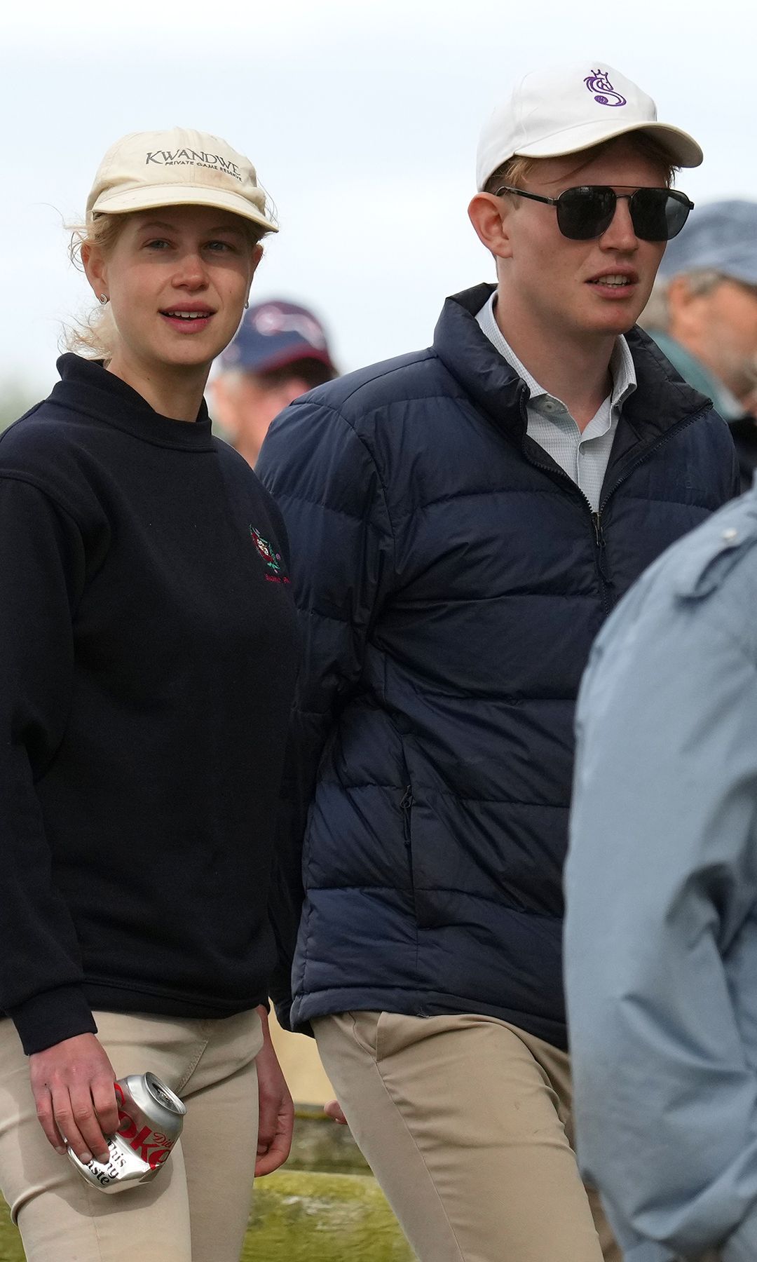 Lady Louise Windsor and Felix da Silva-Clamp in a crowd; Lady Louise carries a Coke can