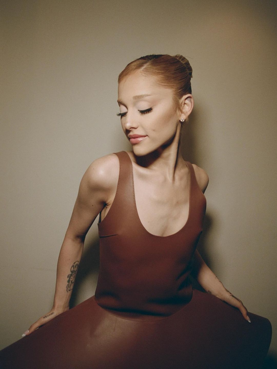 Ariana Grande poses for an Instagram pic in a brown JW Anderson dress