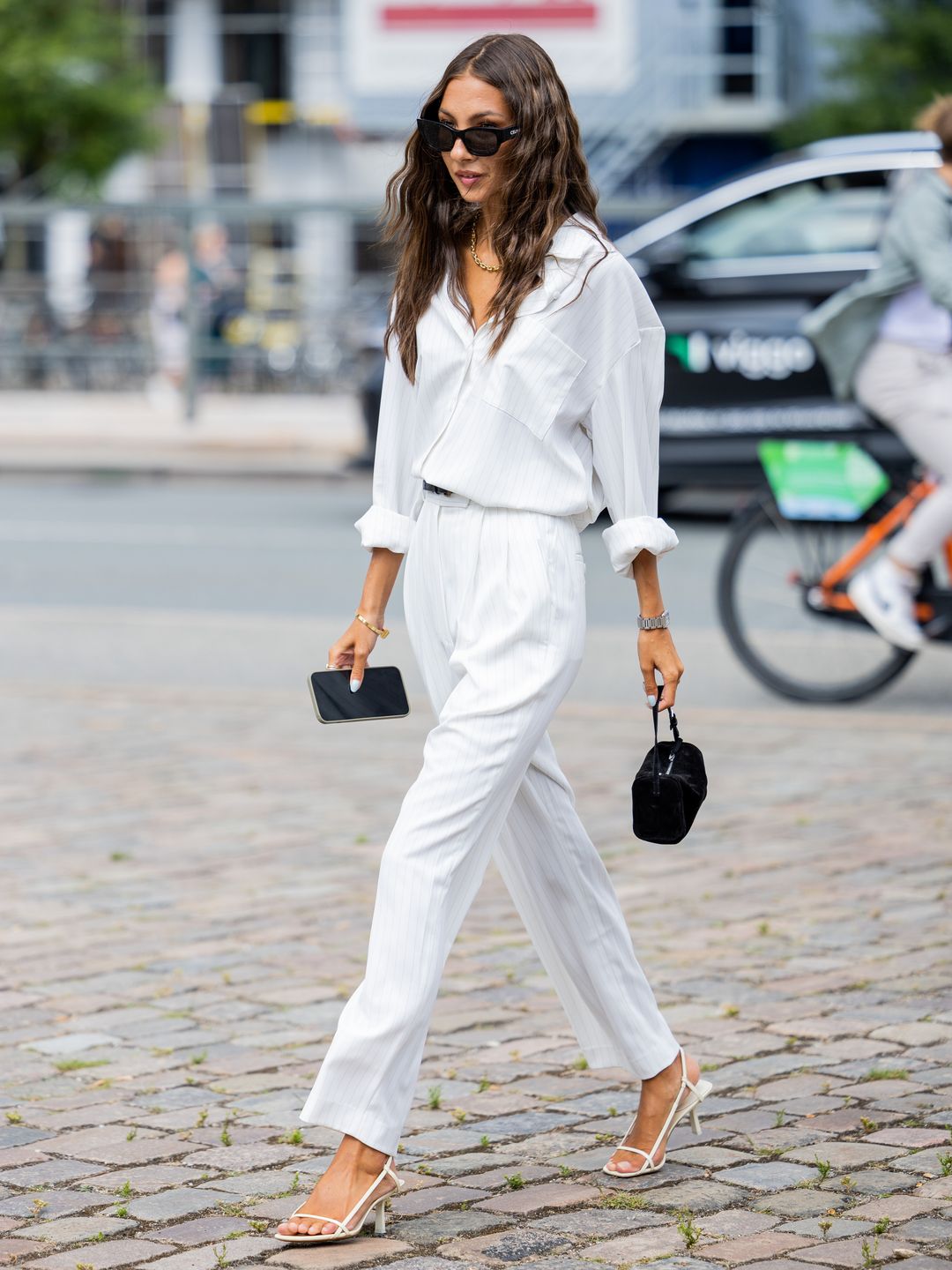 Felicia Akerstrom teams a white shirt with relaxed-fit trousers 