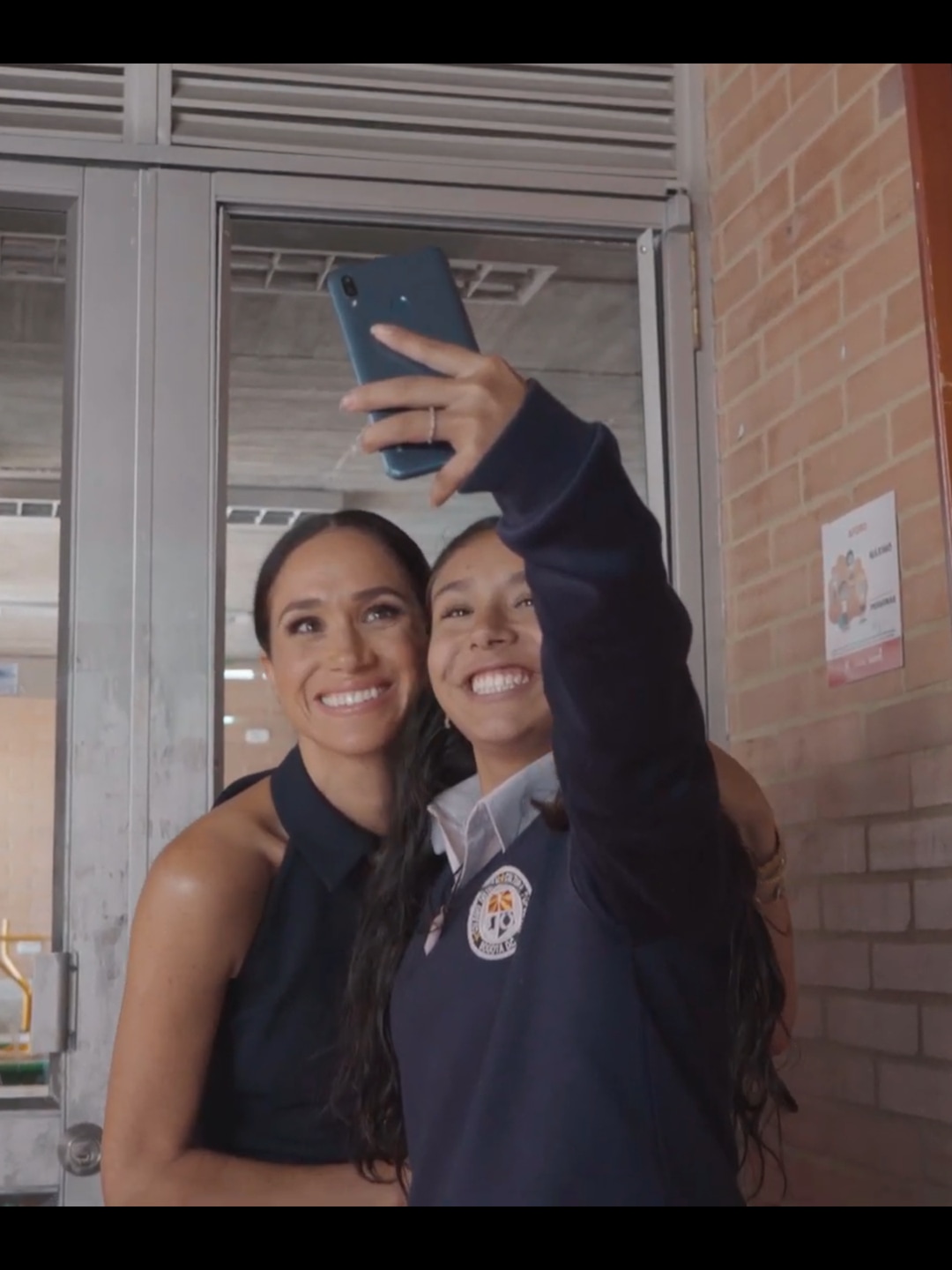 Meghan Markle and a school child taking a selfie