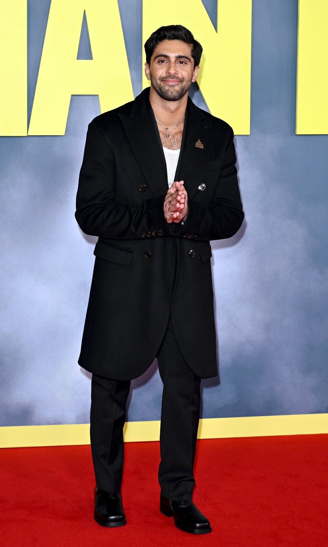 Arian Nik in a black coat