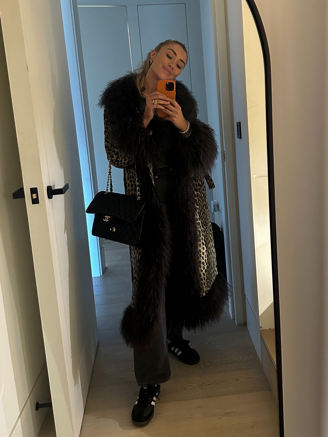  a Charlotte Simone leopard print coat, a pair of Levi’s vintage grey jeans, Chanel bag, black Adidas Sambas and a grey Lisa Yang jumper. 
