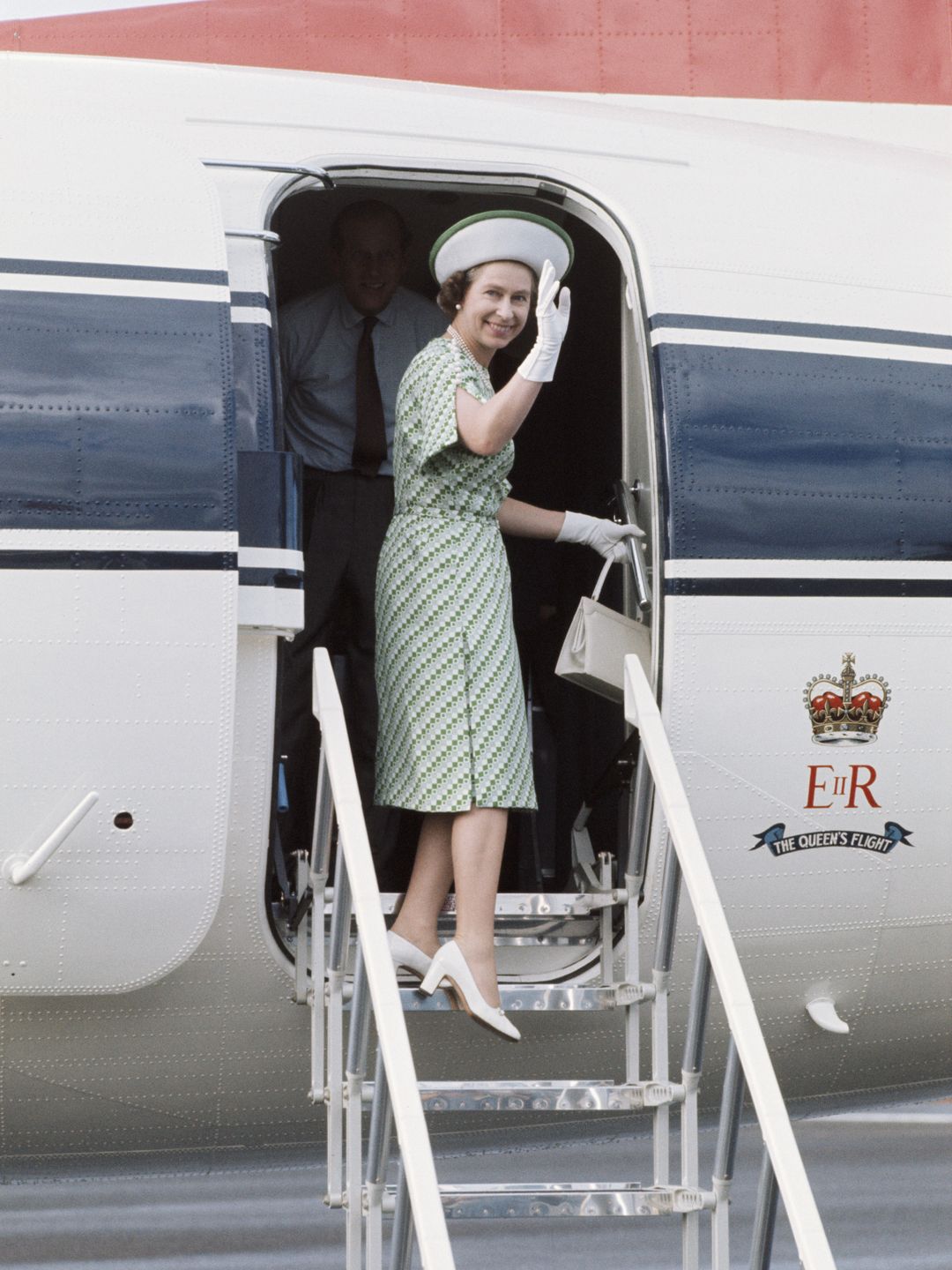 queen getting onto plane 