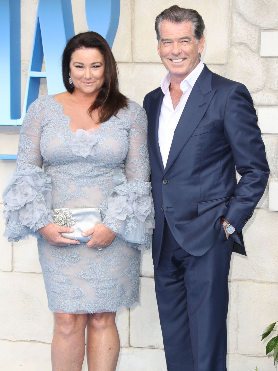 Keely Shaye Smith and Pierce Brosnan smiling at a red carpet shoot