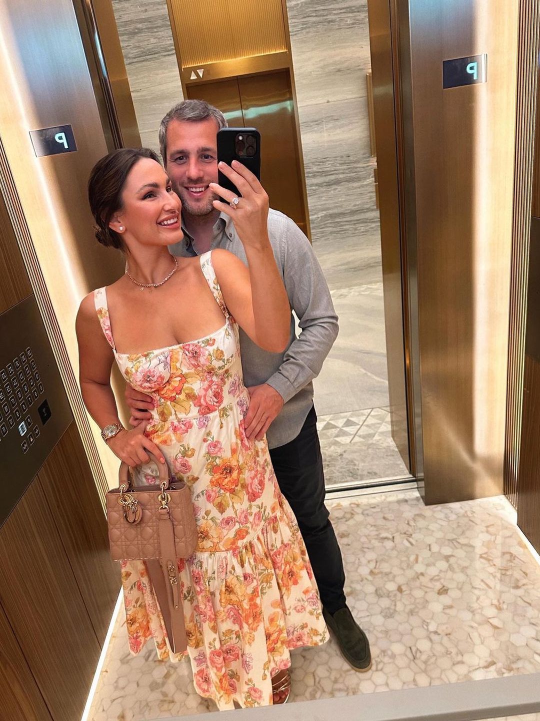 Sam Faiers wearing a diamond ring and floral dress in a mirror selfie with Paul