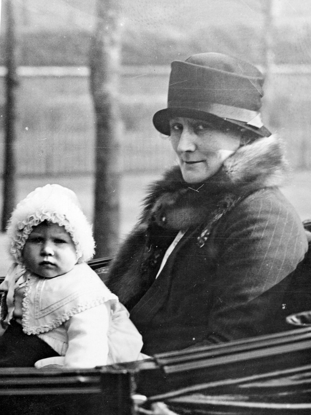 A Baby Queen Elizabeth in a bonnet with an unknown woman