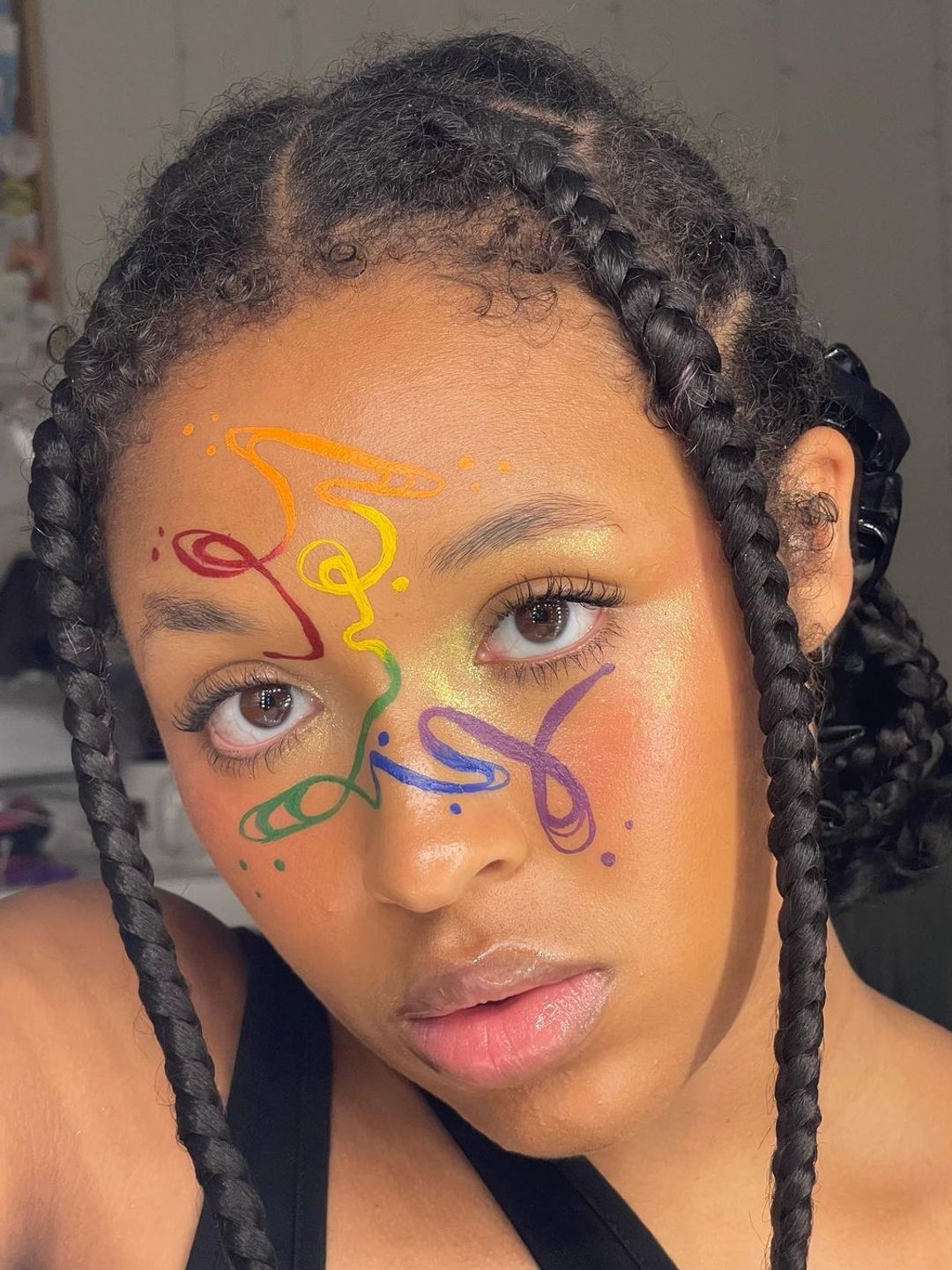 Rainbow squiggly line work makeup down the centre of the face
