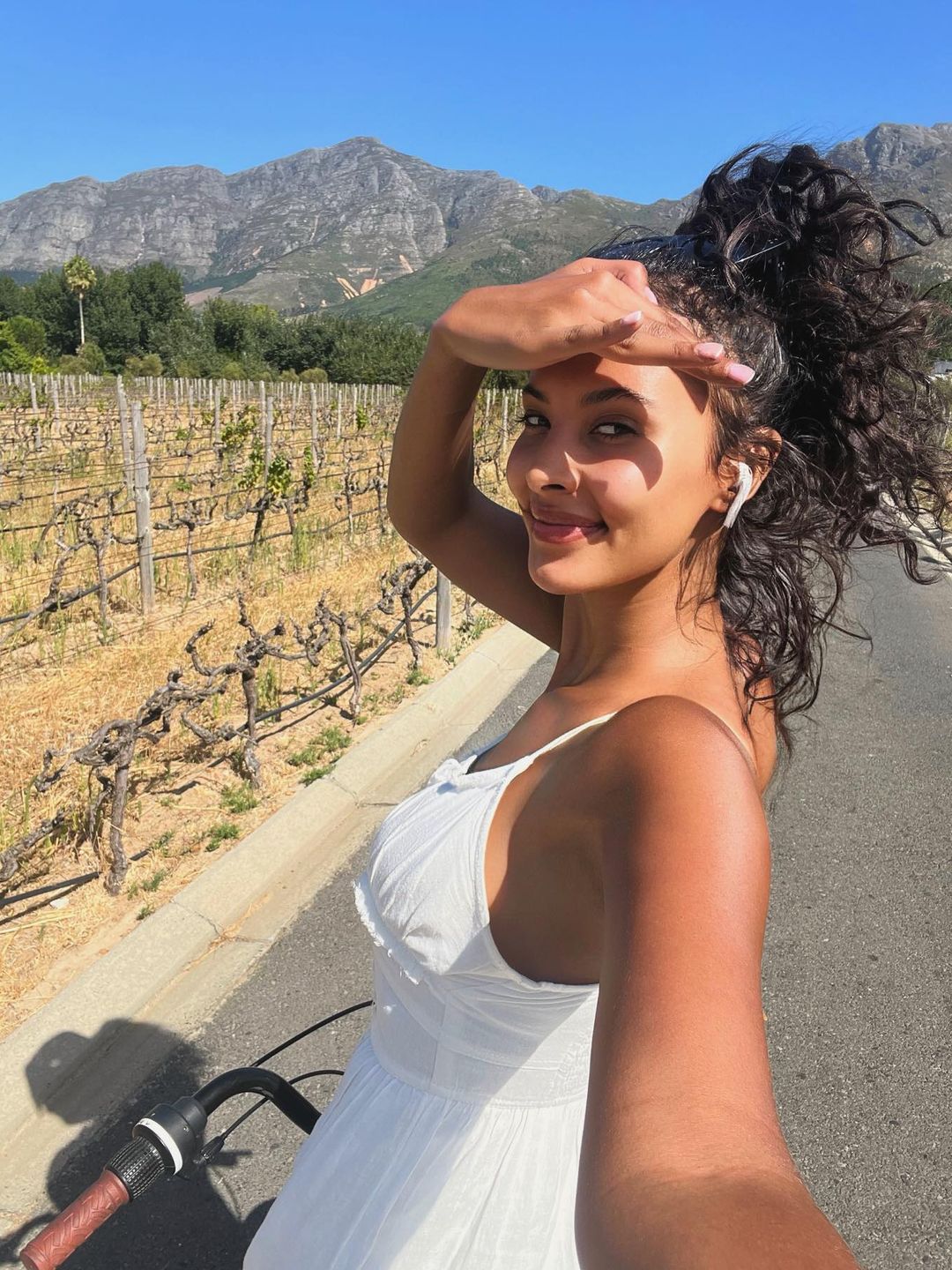Maya Jama wears a white sundress to go cycling in South Africa