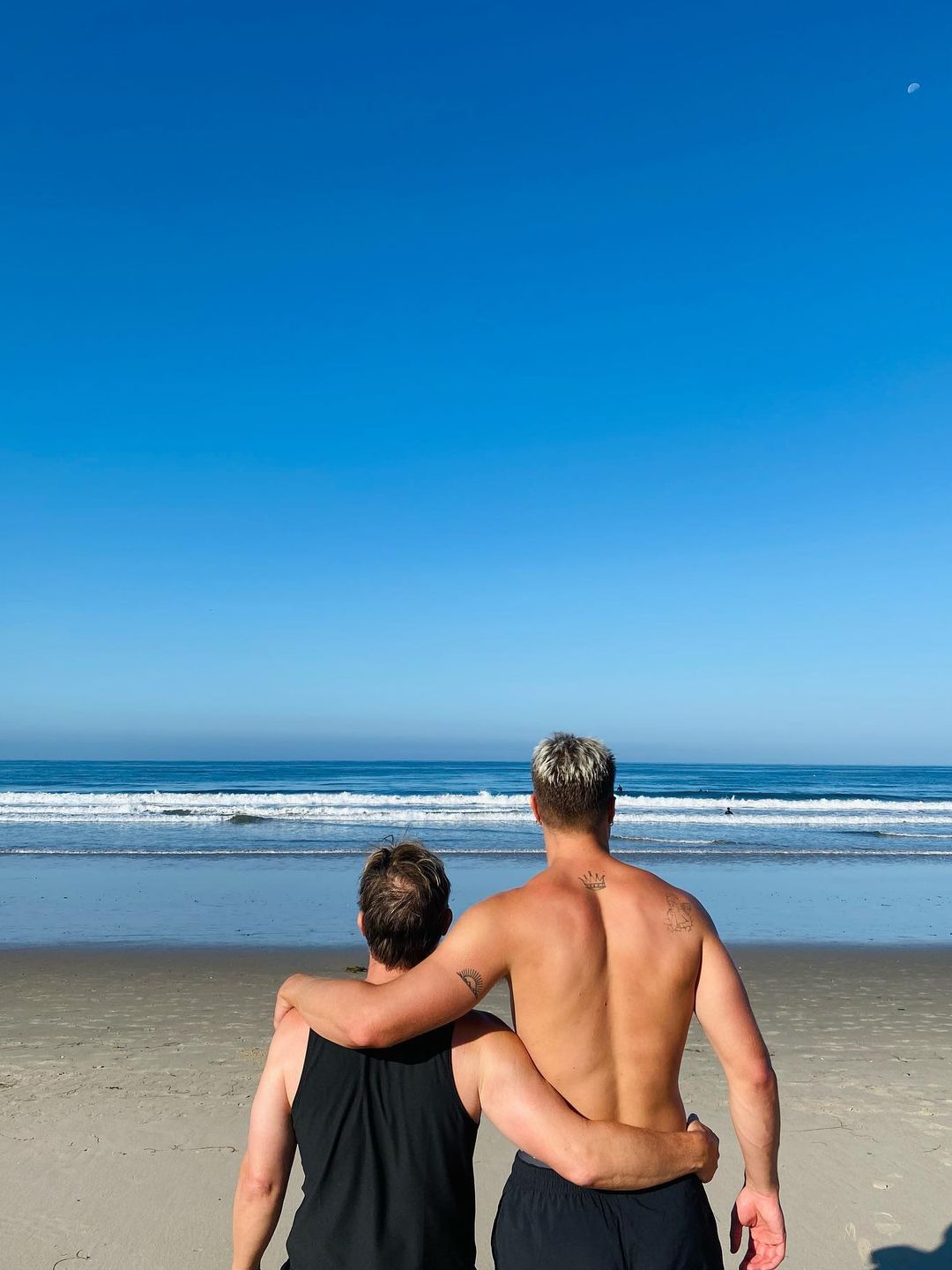 father and son hugging at beach