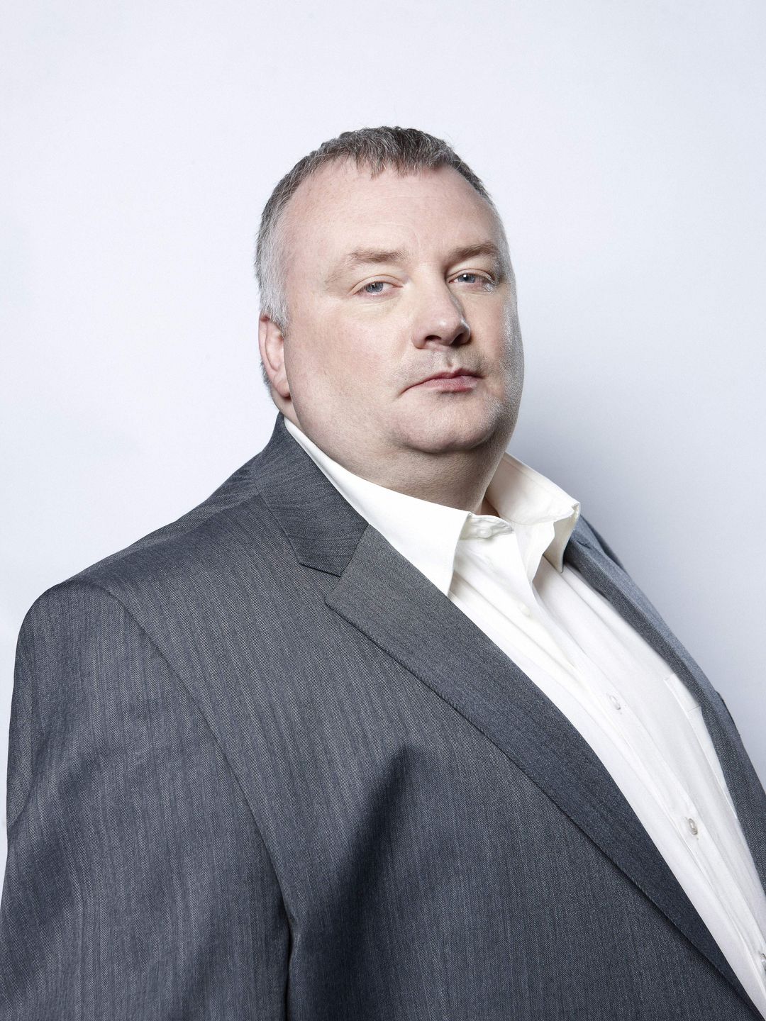 Stephen Nolan in a gray suit. 