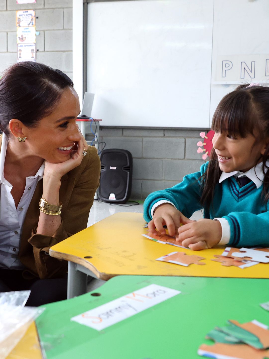 Meghan Markle talking to a young girl