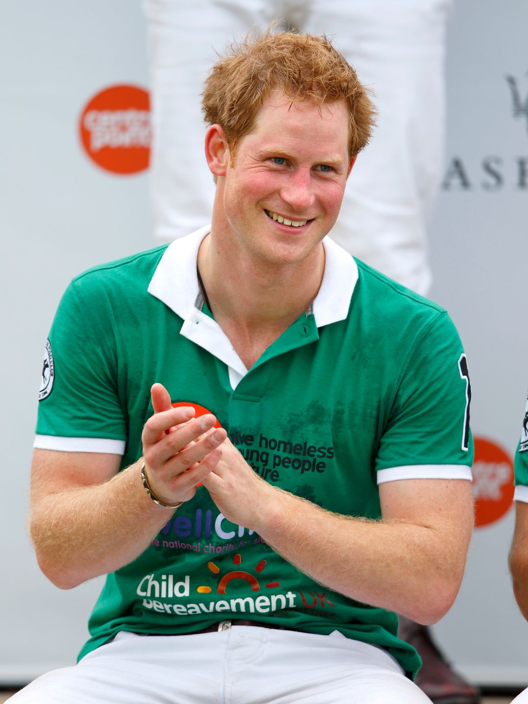 prince harry clapping in green top 