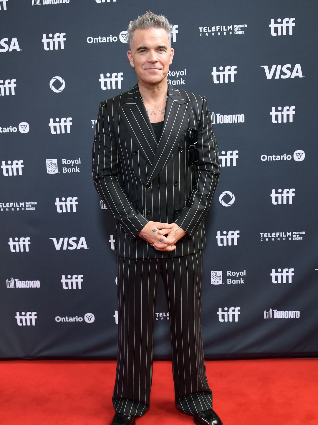 man in pinstripe suit on red carpet