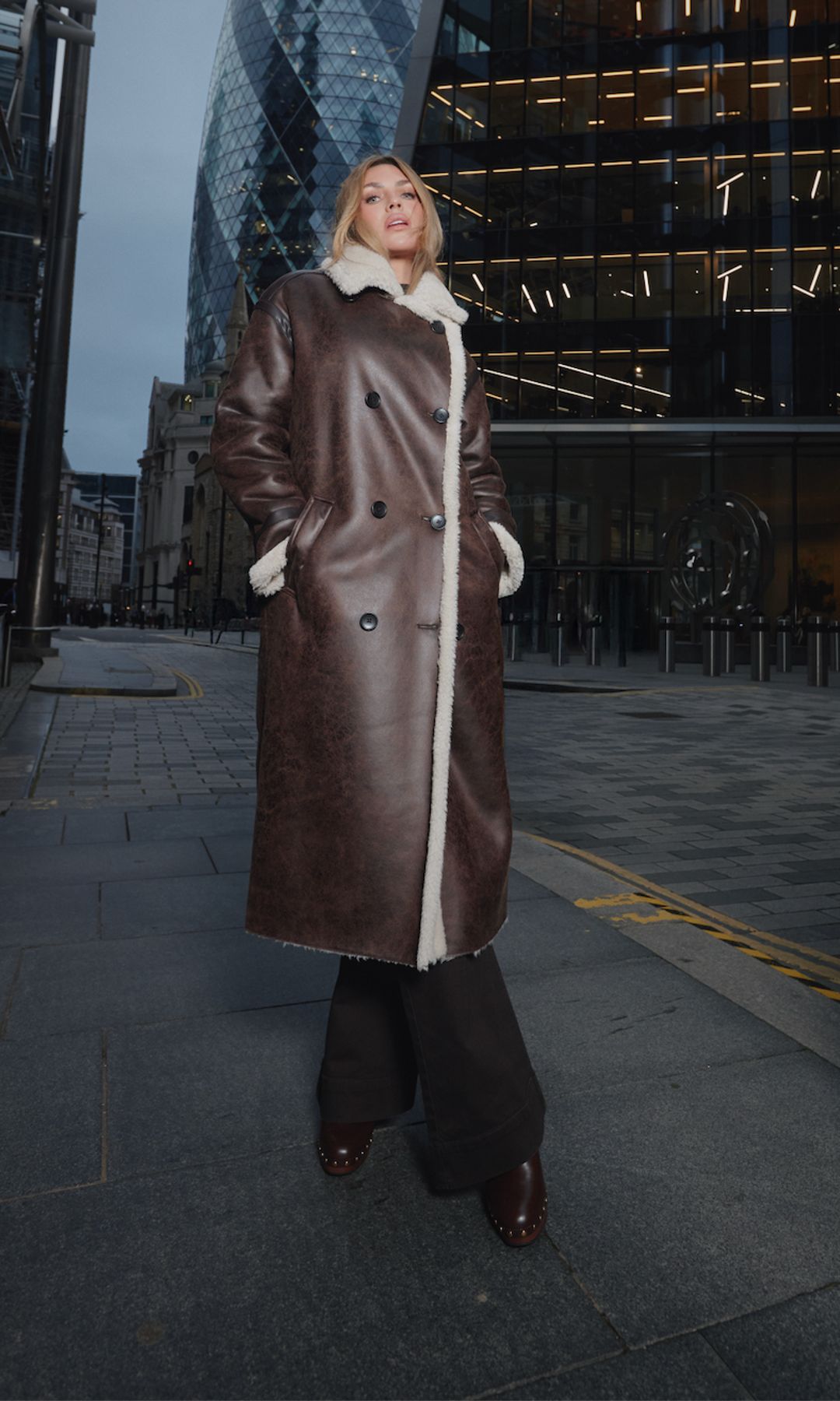 Abbey Clancy posing in London in shearling coat