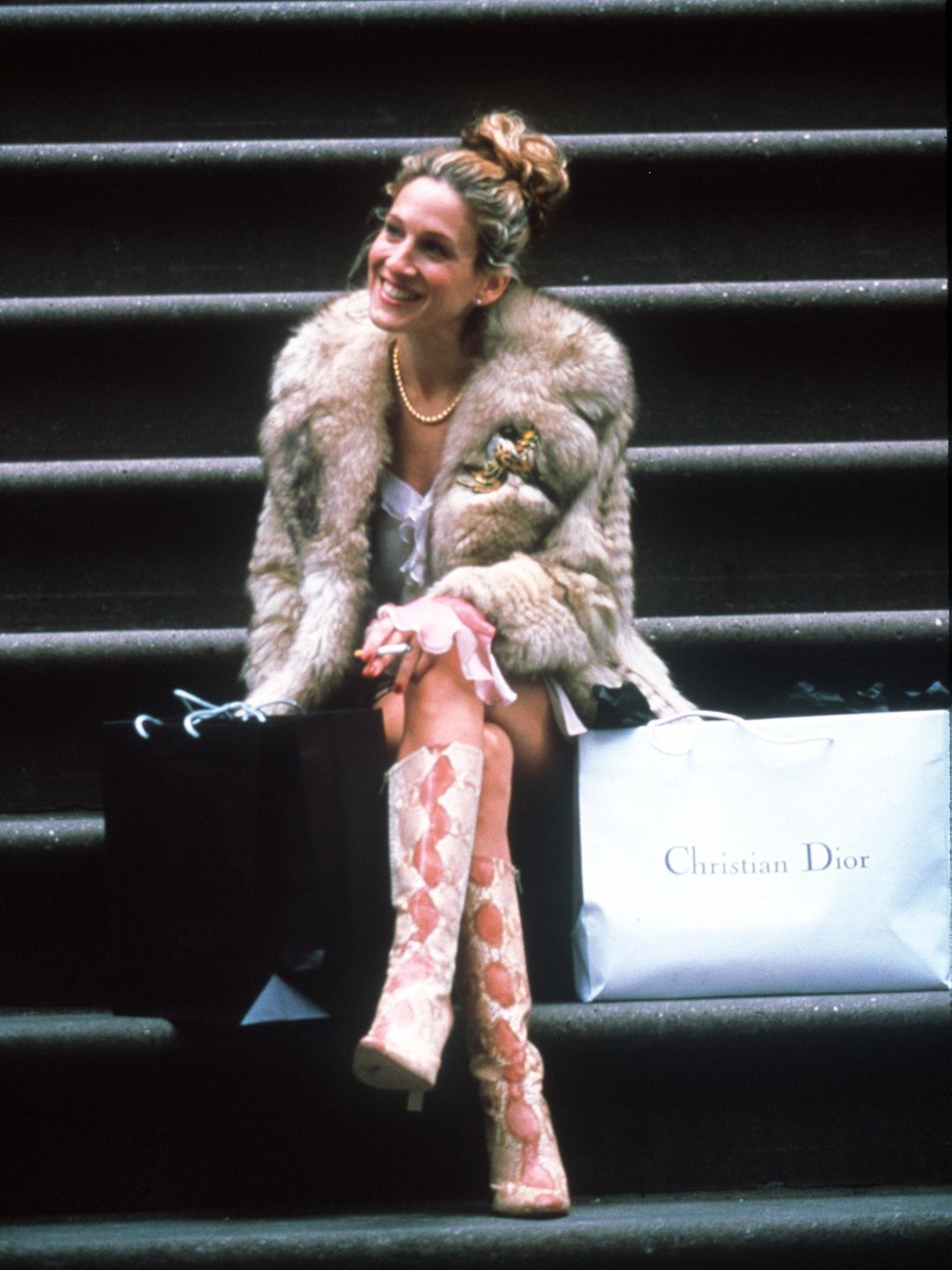 Carrie paired her snakeskin boots with a sumptuous fur coat 