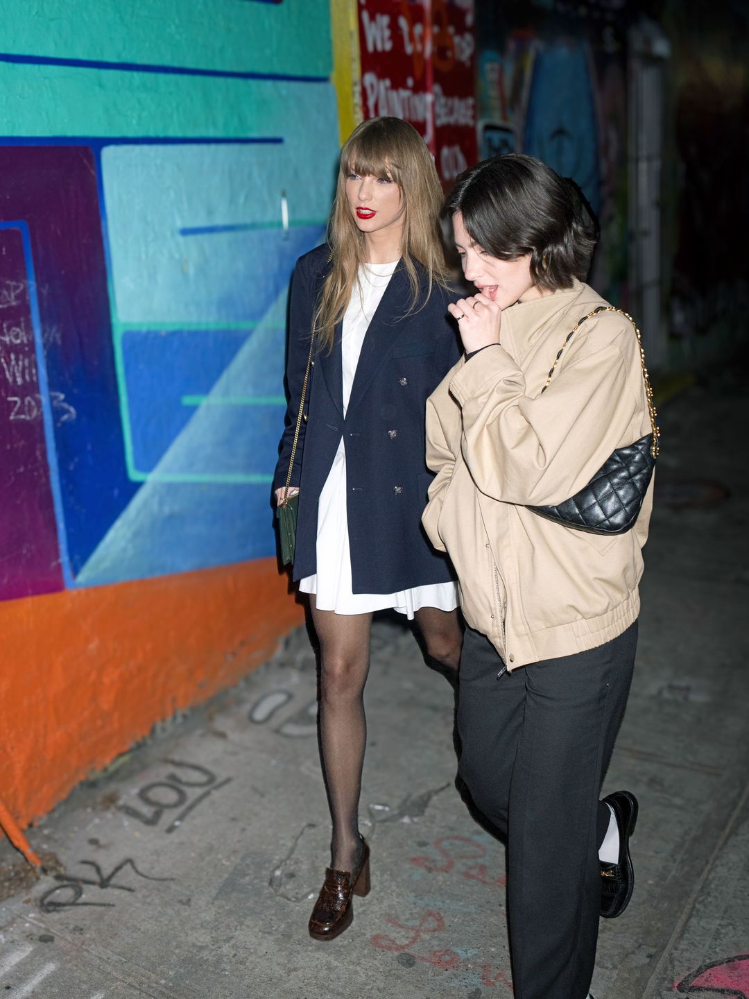 Taylor Swift wearing sheer tights alongside heeled loafers 