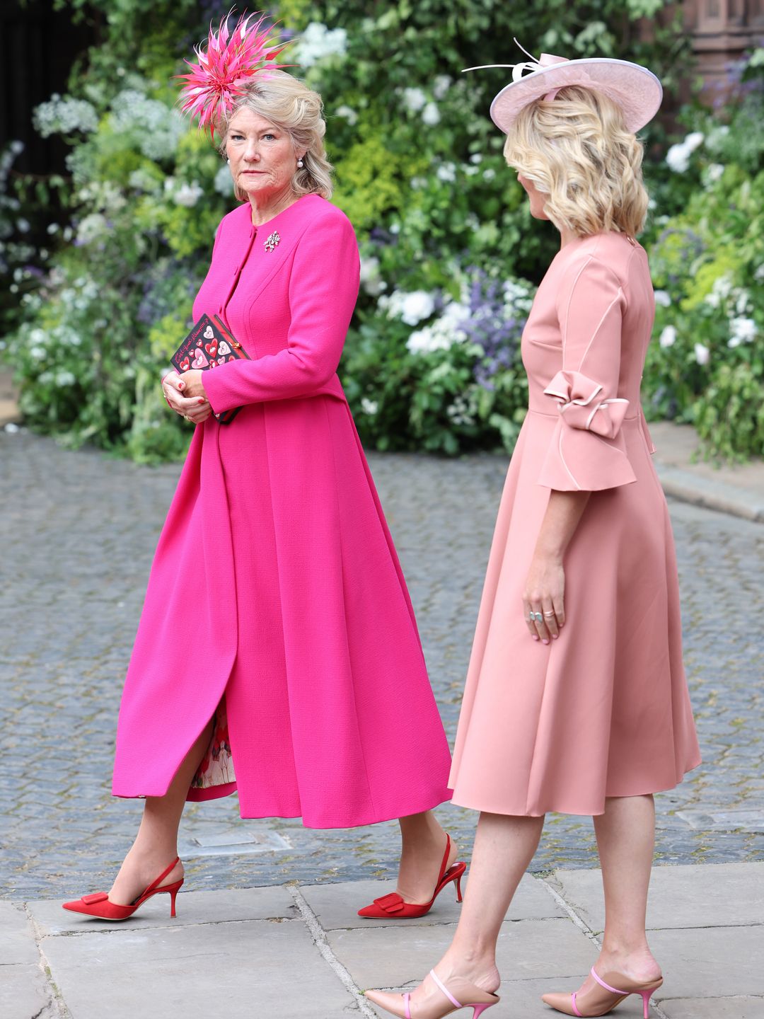 The mother of the groom, Natalia Grosvenor, Duchess of Westminster, arrived wearing a pink dress and pink fascinator