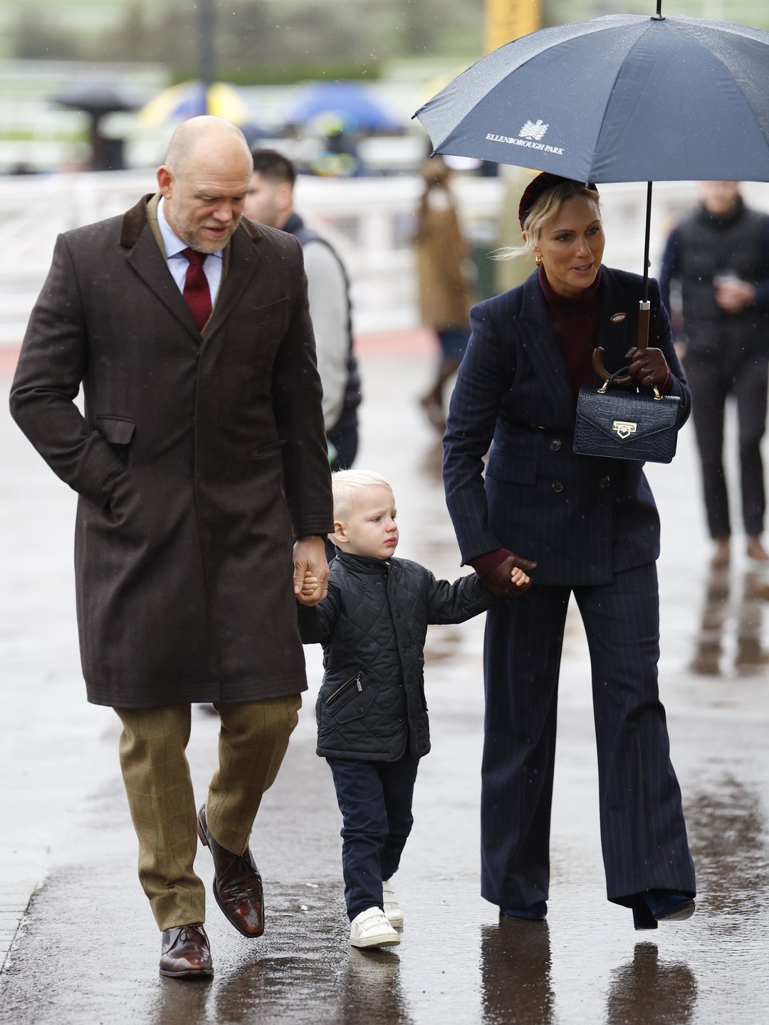 family walking in rain 