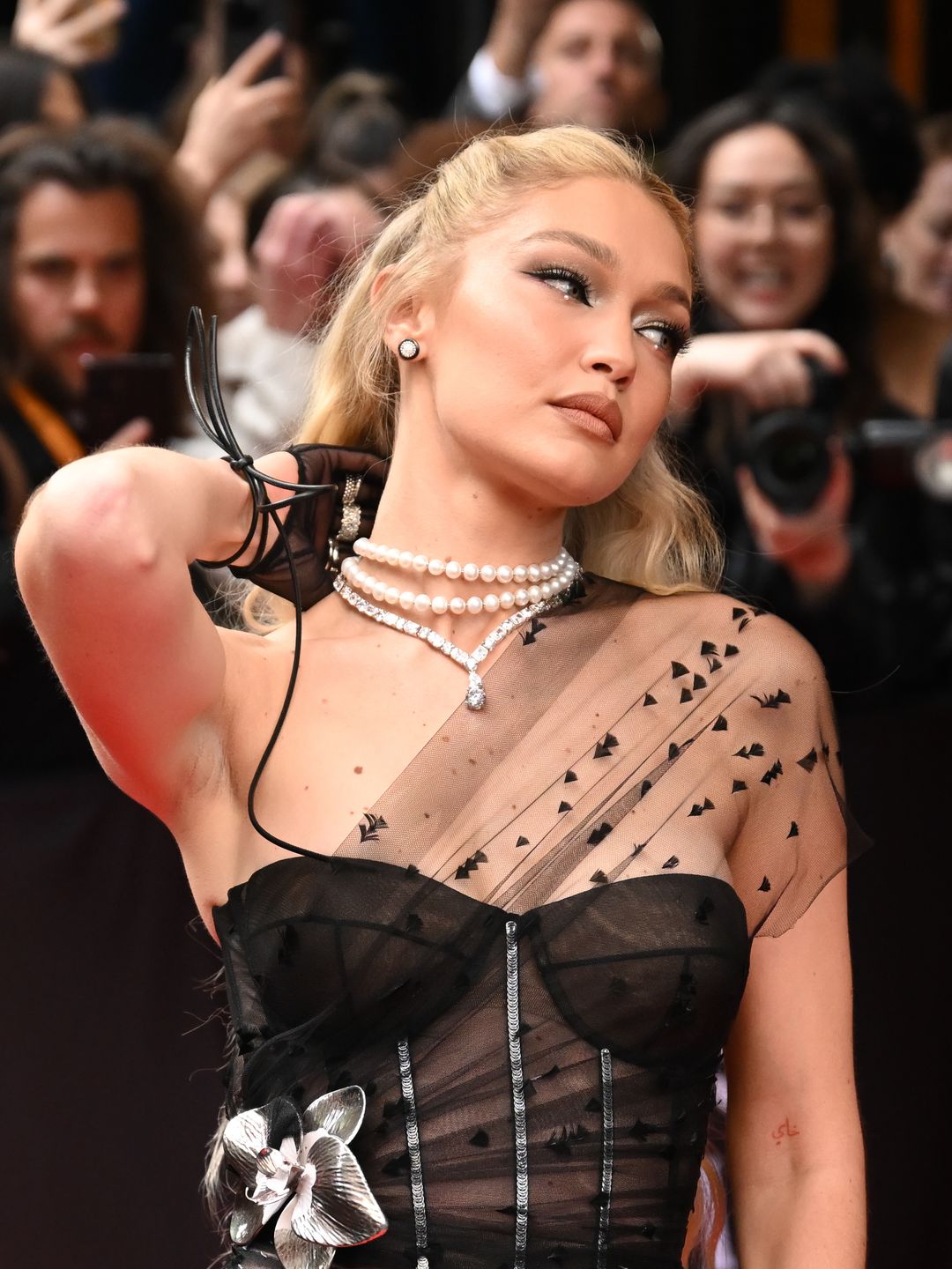 Gigi Hadid attends the Met Gala in a mesh corset dress from Givenchy