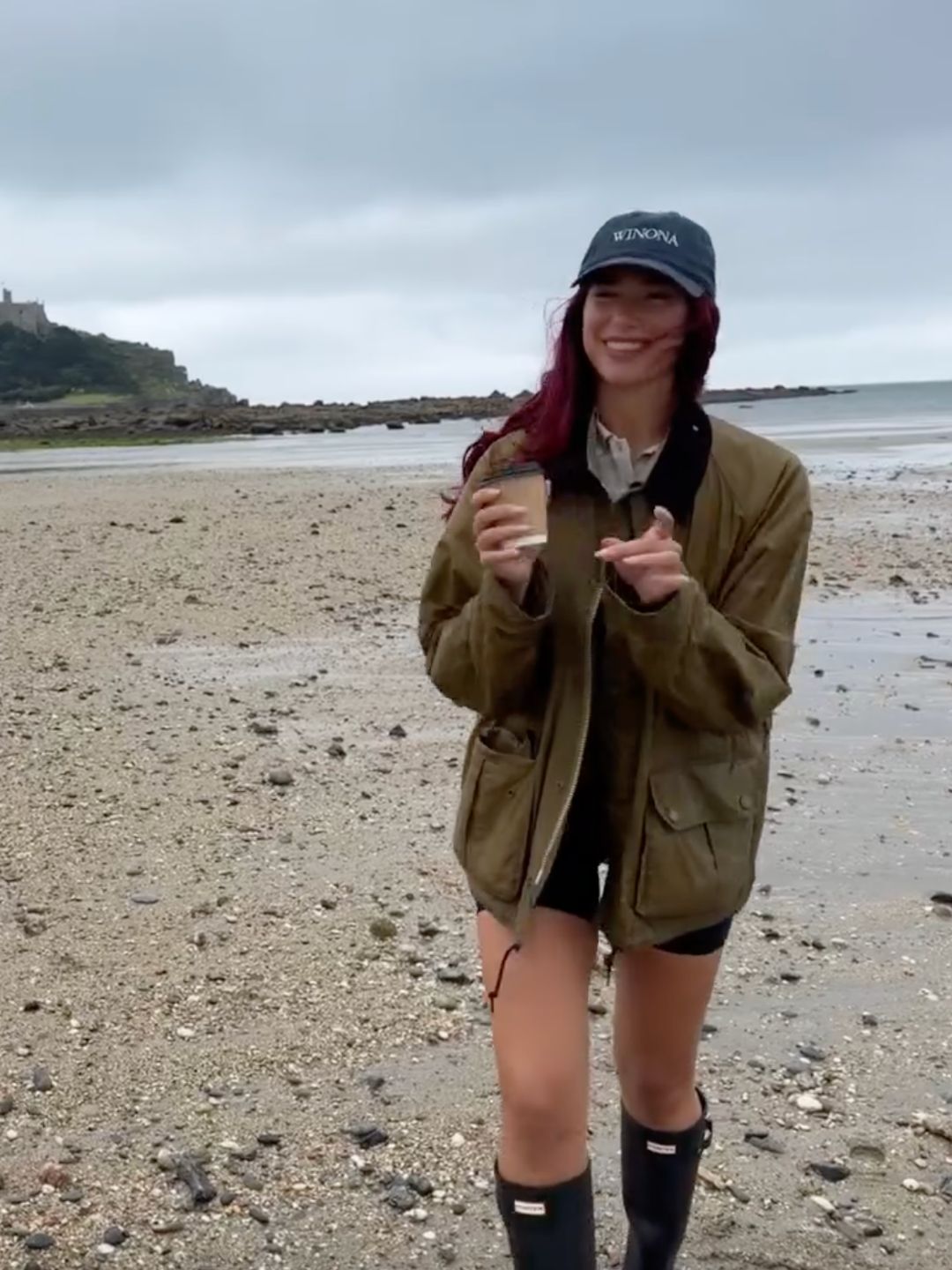 Dua lipa posts a video of herself in Wellington boots while at a UK beach