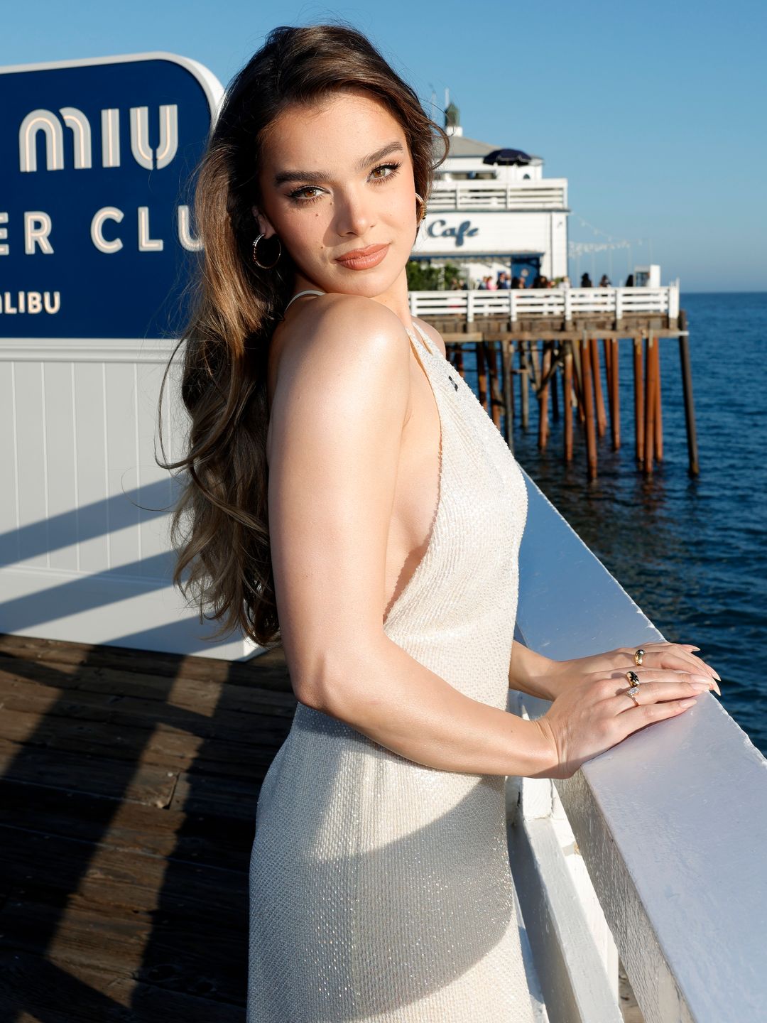 Hailee Steinfeld posing for a photo on a pier