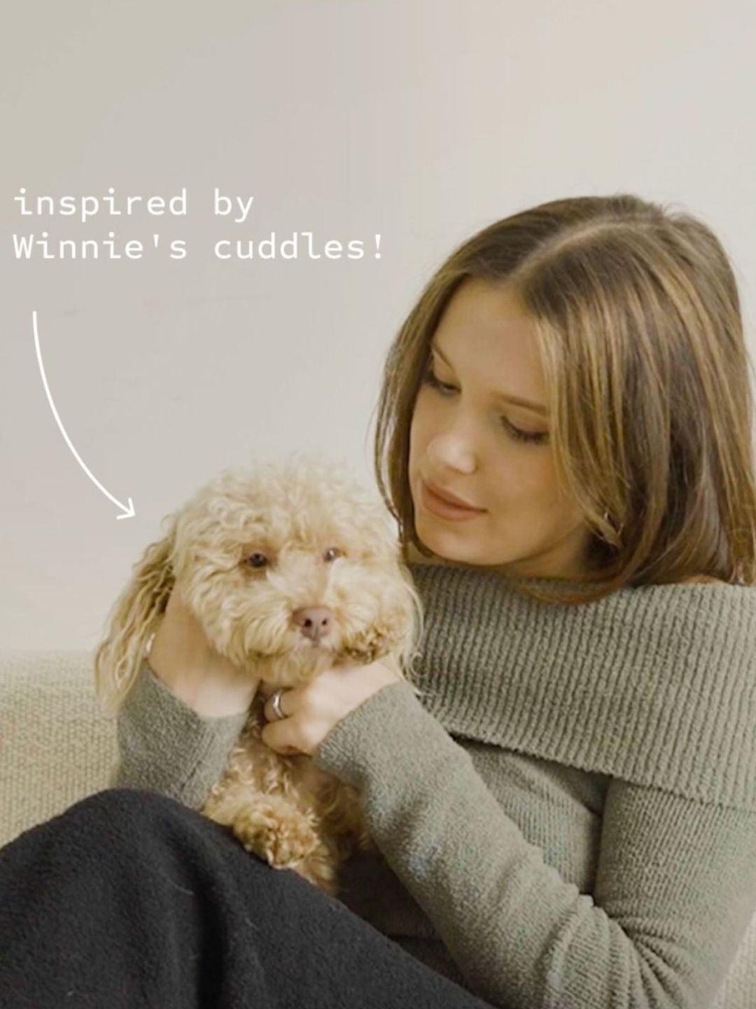 Millie Bobby Brown poses on a couch with her dog Winnie