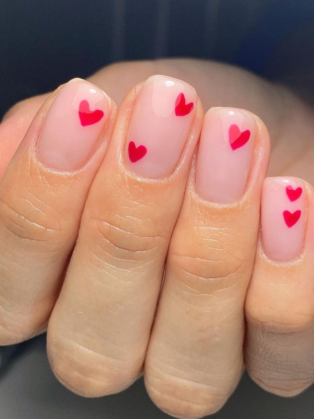 Pink squoval nails with red hearts 