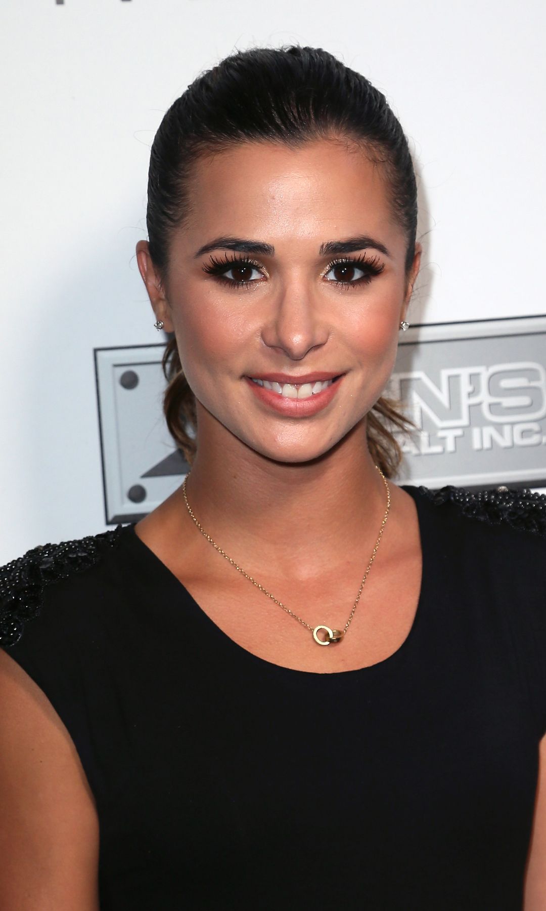 Josie Loren in a black dress at a charity ball