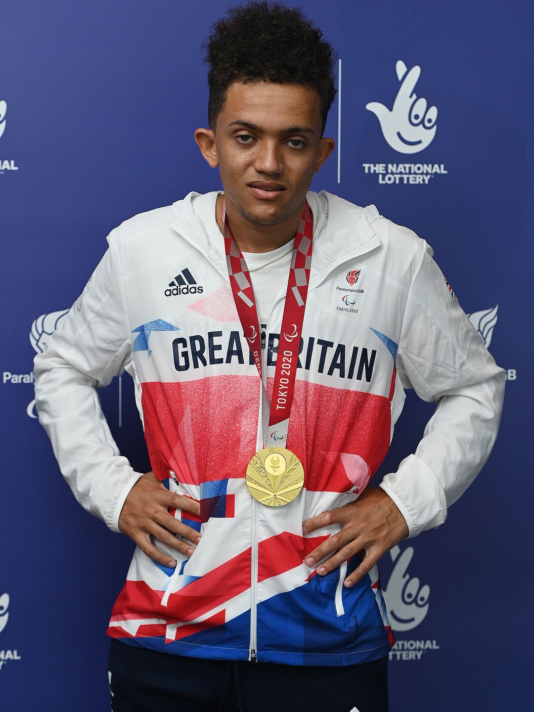 Thomas Young in Team GB kit with a gold medal