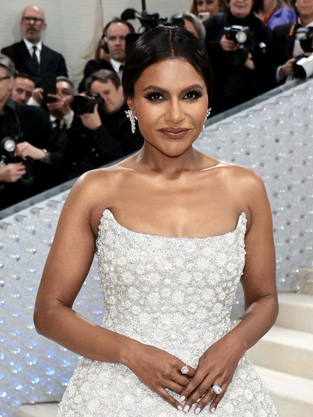 Mindy Kaling with a sleek updo and glossy lips at the 2023 Met Gala 