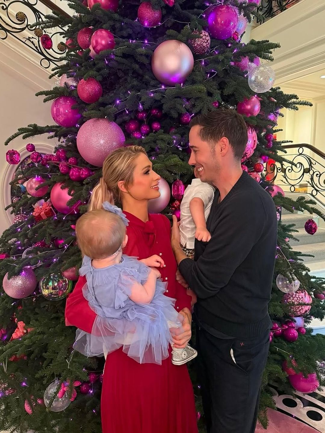 Paris Hilton and her husband Carter Reum, plus their children London and Phoenix, pose in front of the Christmas tree on Thanksgiving, shared on Instagram