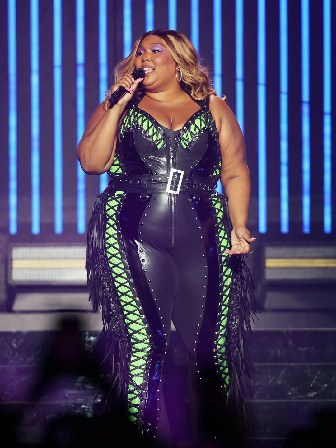  Lizzo performs at Qudos Bank Arena in Sydney wearing black leather catsuit with neon green detailing