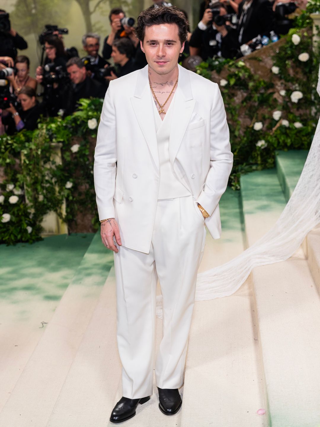 Brooklyn Beckham attends the 2024 Met Gala in a white Dior suit