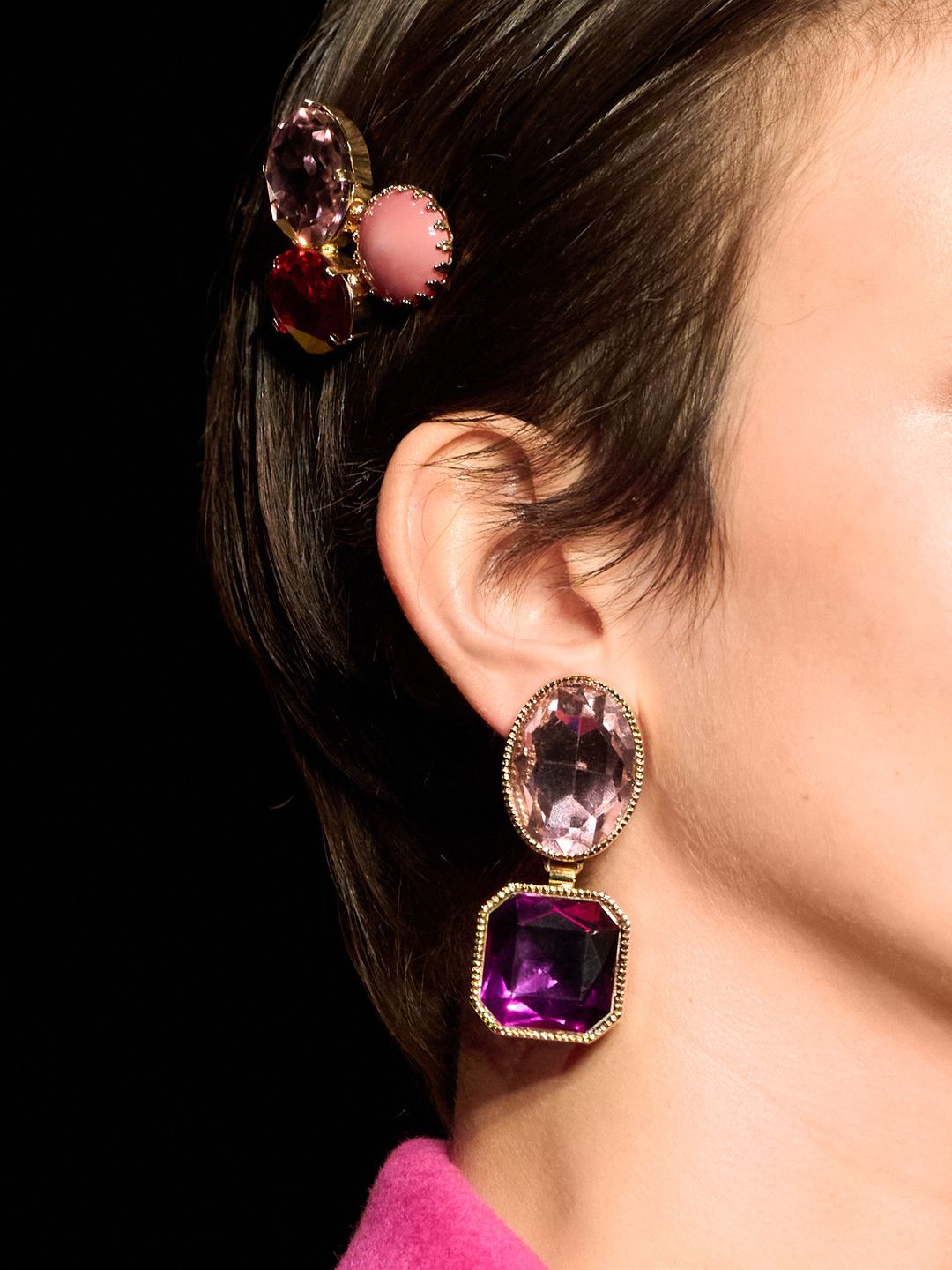 Model wearing pink and purple gemstone earrings 