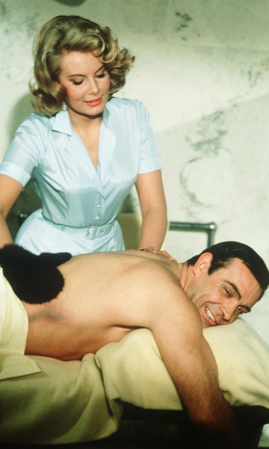 Molly Peters as Patricia Fearing giving Sean Connery a back massage in Thunderball