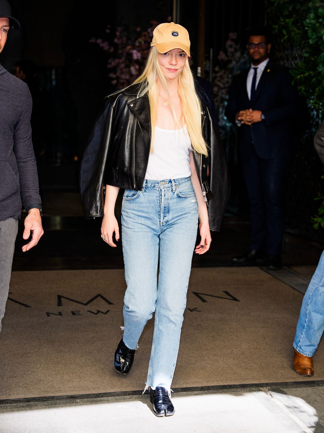  Anya Taylor-Joy is seen in Midtown on April 16, 2024 in New York City wearing blue jeans, a white tank top and a leather jacket